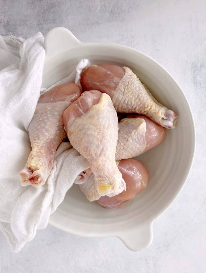 bowl with chicken legs and a towel