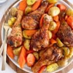 plate of chicken legs with potatoes and carrots