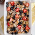 baked french toast in a casserole dish with berries