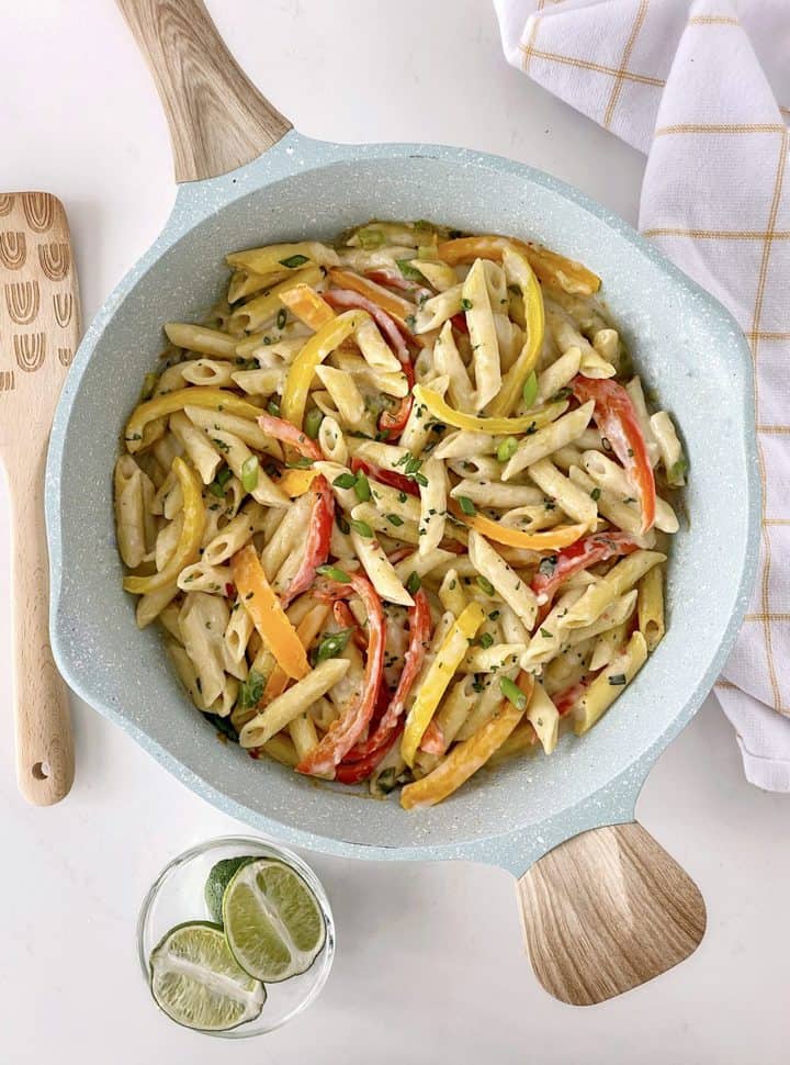 cooked pasta and bell peppers in a pan