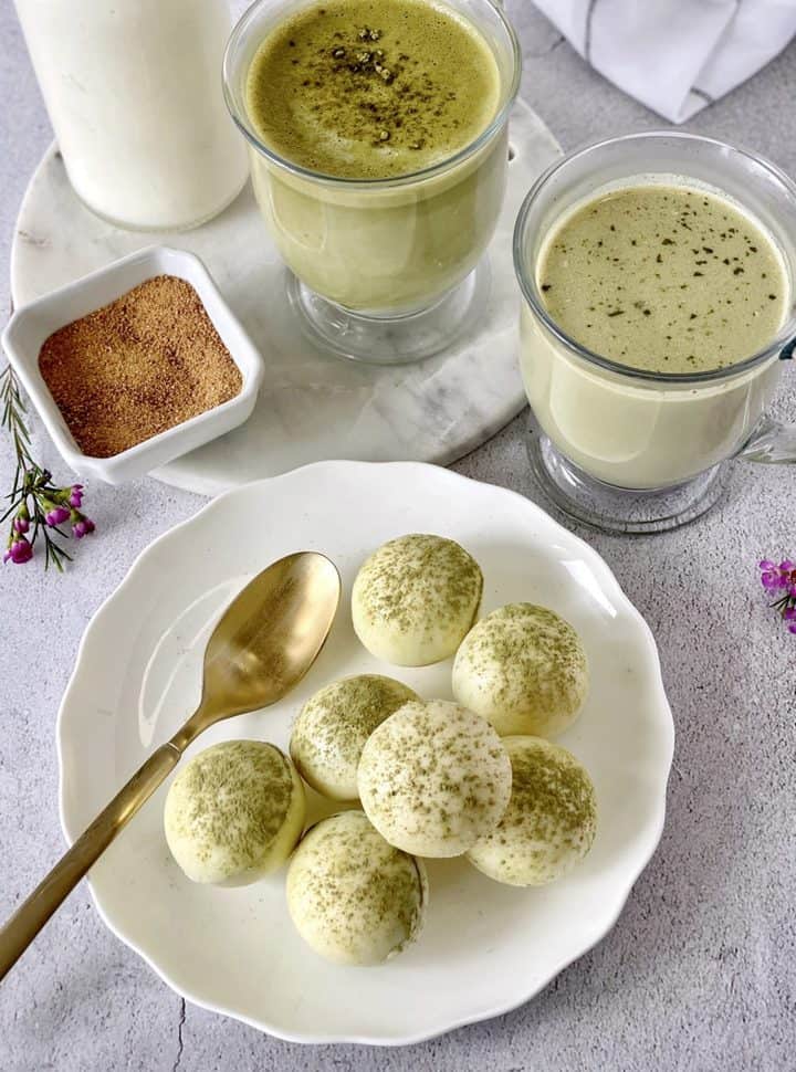 plate with matcha bombs and cups of matcha