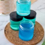 hand sanitizer jars in bottle on cork board