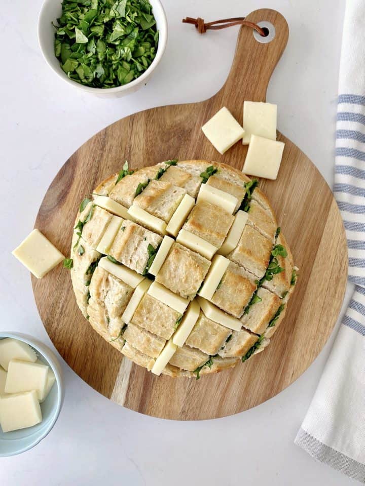 cheese squares into the loaf next to it and spinach in a bowl