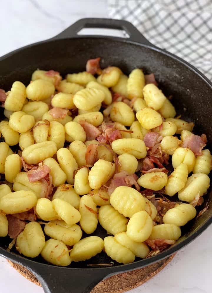 gnocchi in a skillet with bacon