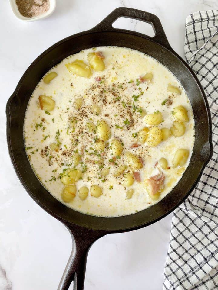 skillet with half and half cream and gnocchi