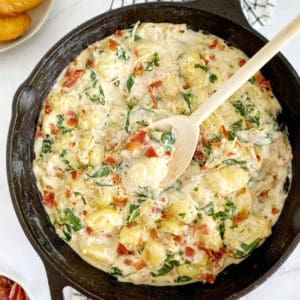 skillet with gnocchi and a spoon in a skillet