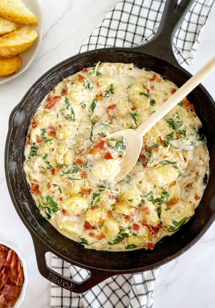 skillet with gnocchi and a spoon in a skillet 