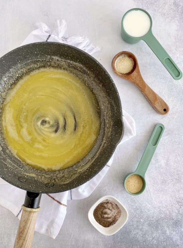 butter in pan next to seasonigs