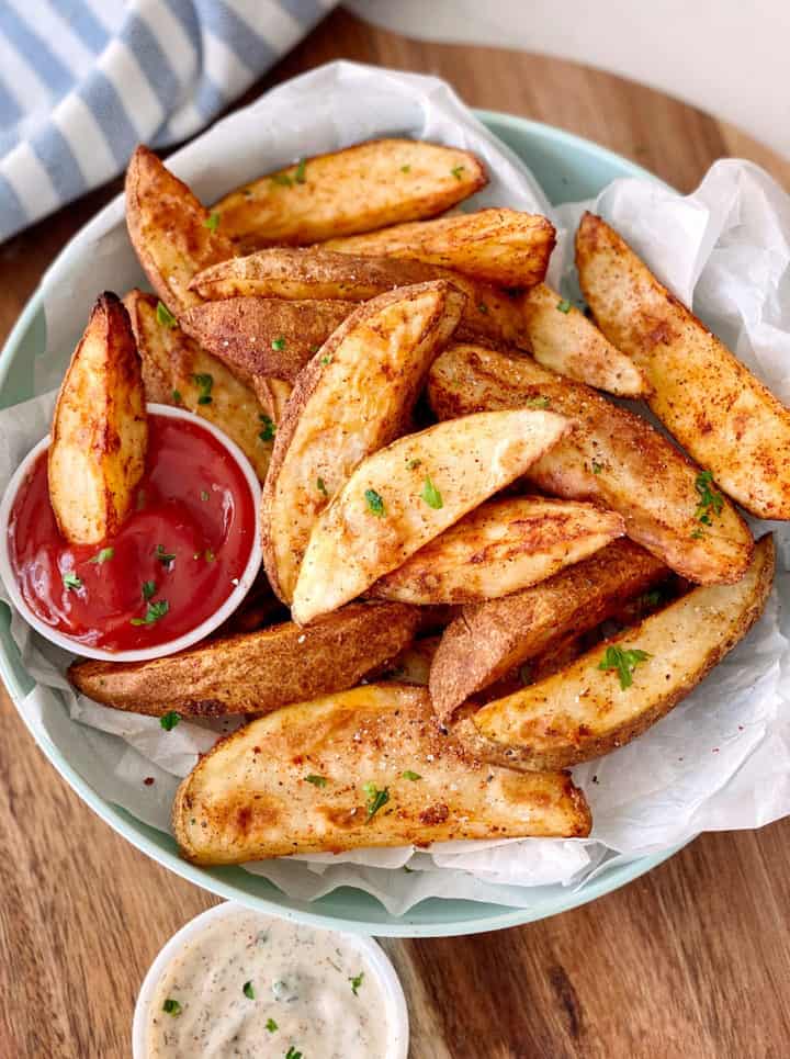 potato wedges on a plate with ketchup 