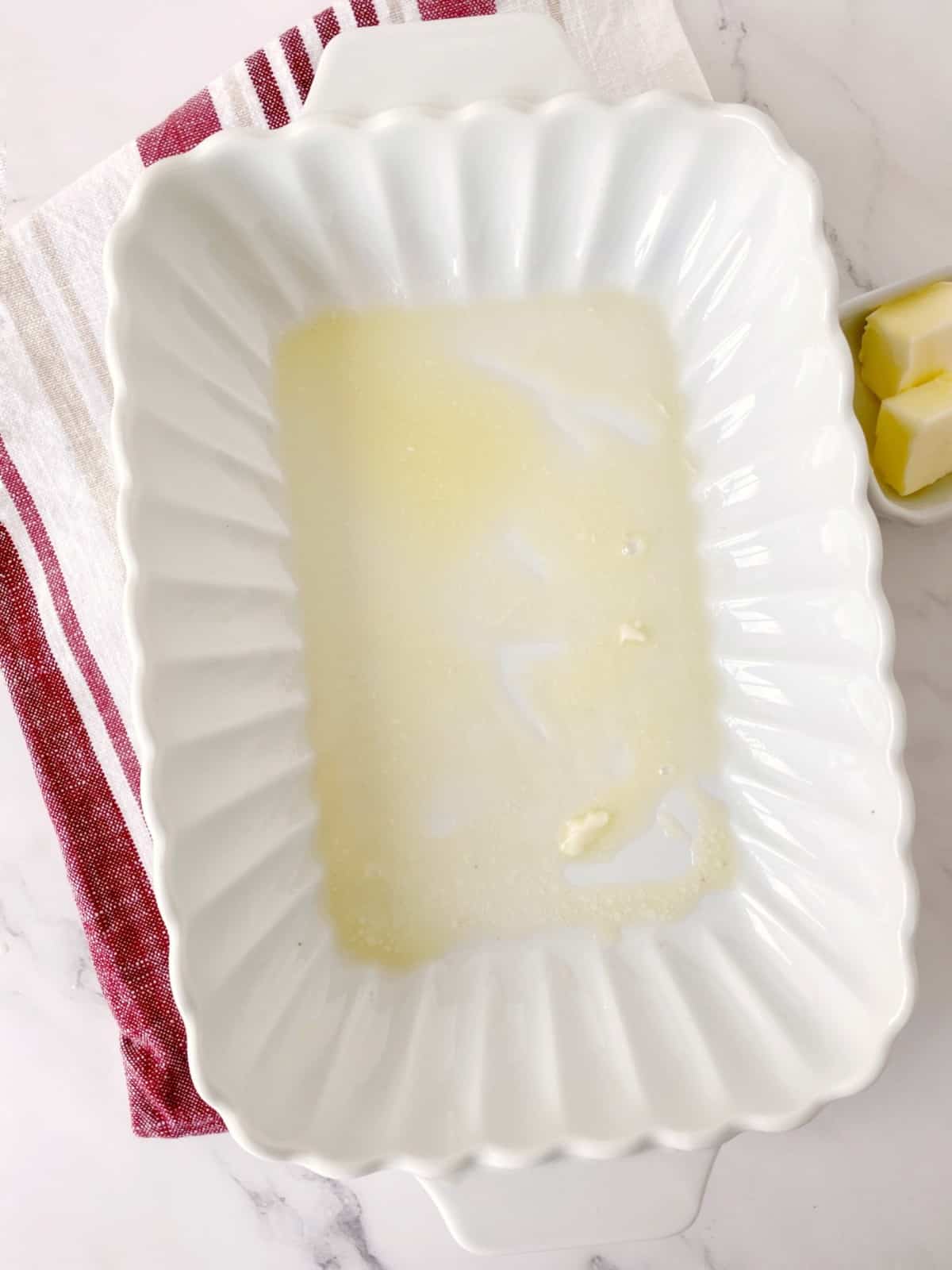 baking dish with melted butter 