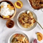 plates of peach cobbler with ice cream on the sidea