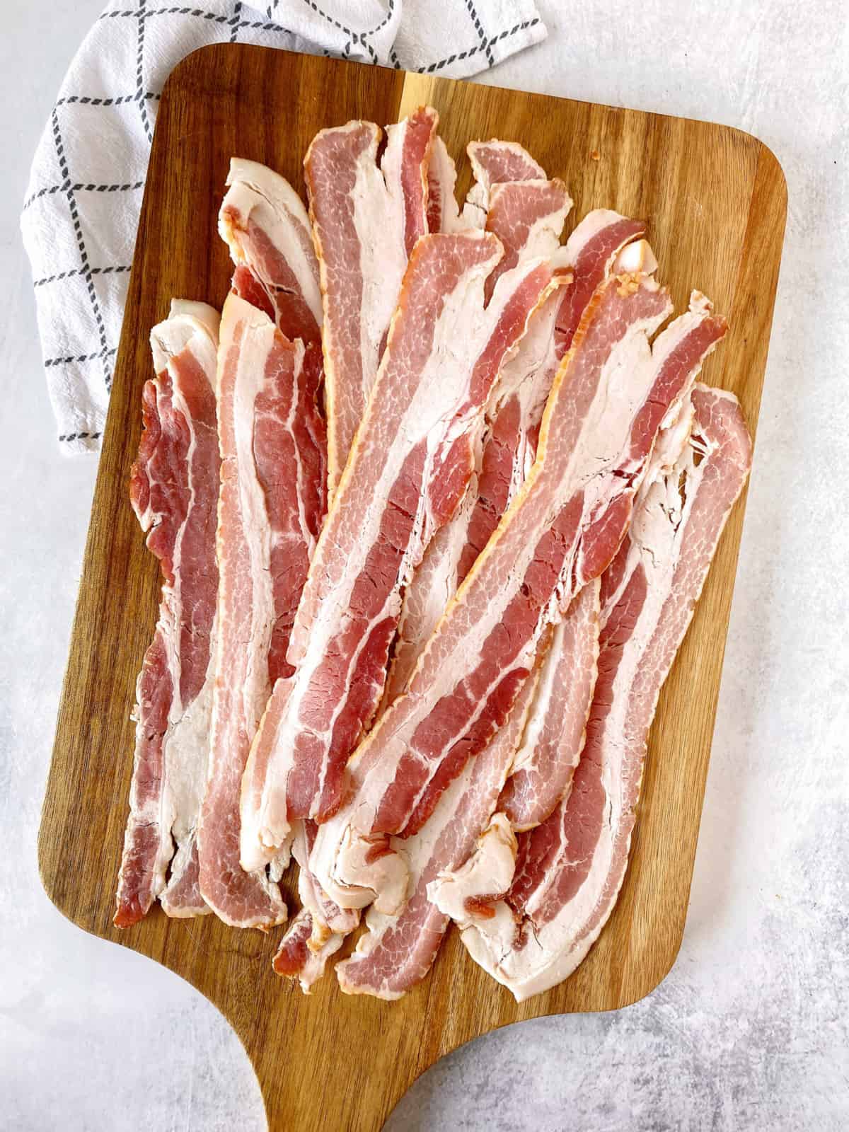 bacon laid on a wooden board