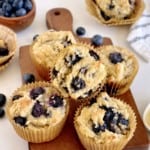 close up of keto blueberry muffins on a wood tray