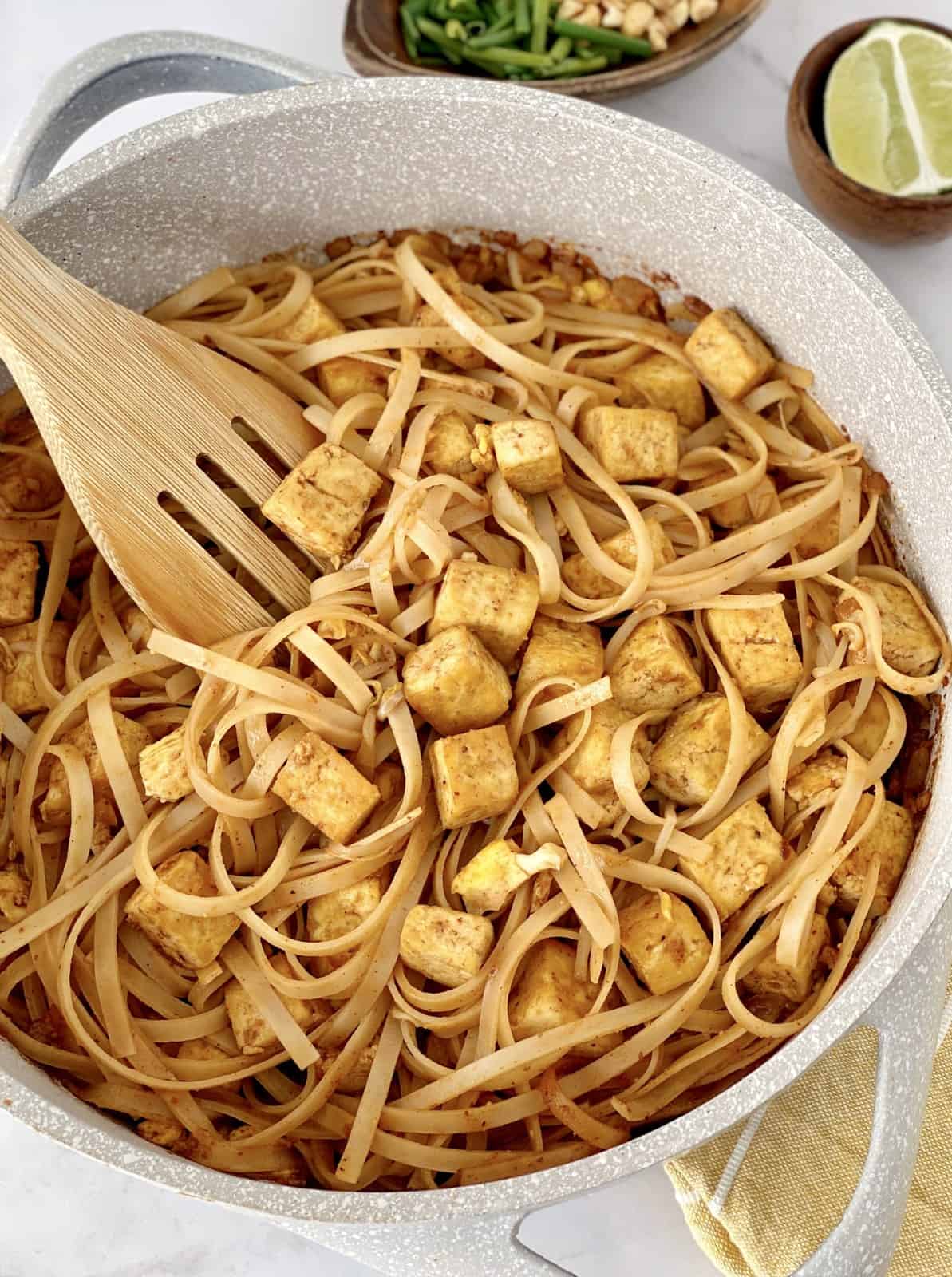noodles and tofu in a pan 