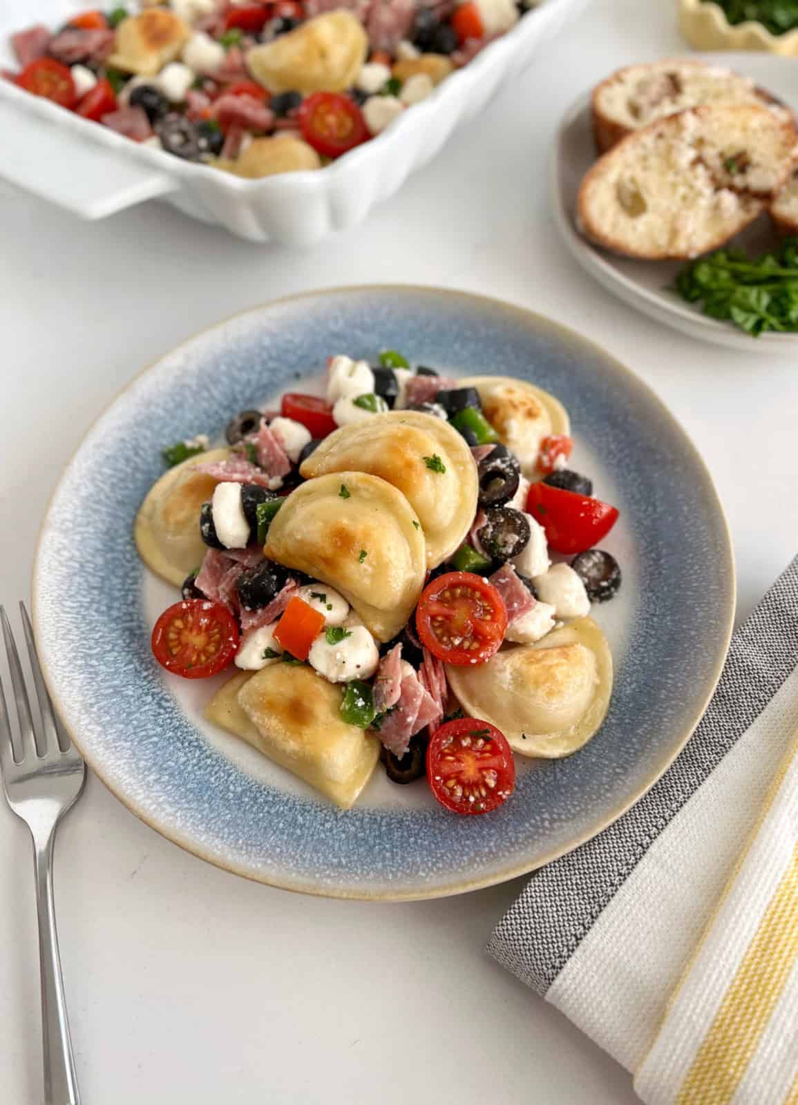 plate with pierogies and vegetables with dressing