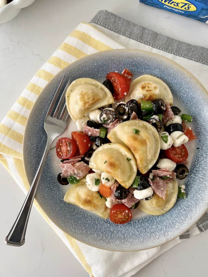 plate of pierogies with tomatoes