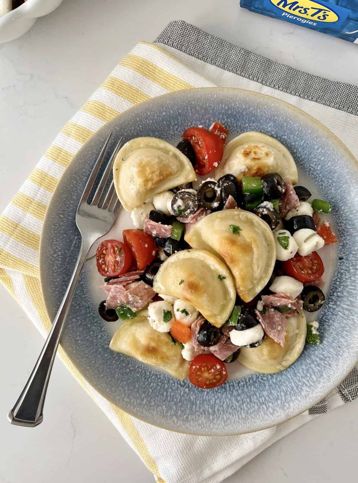 plate of pierogies with tomatoes