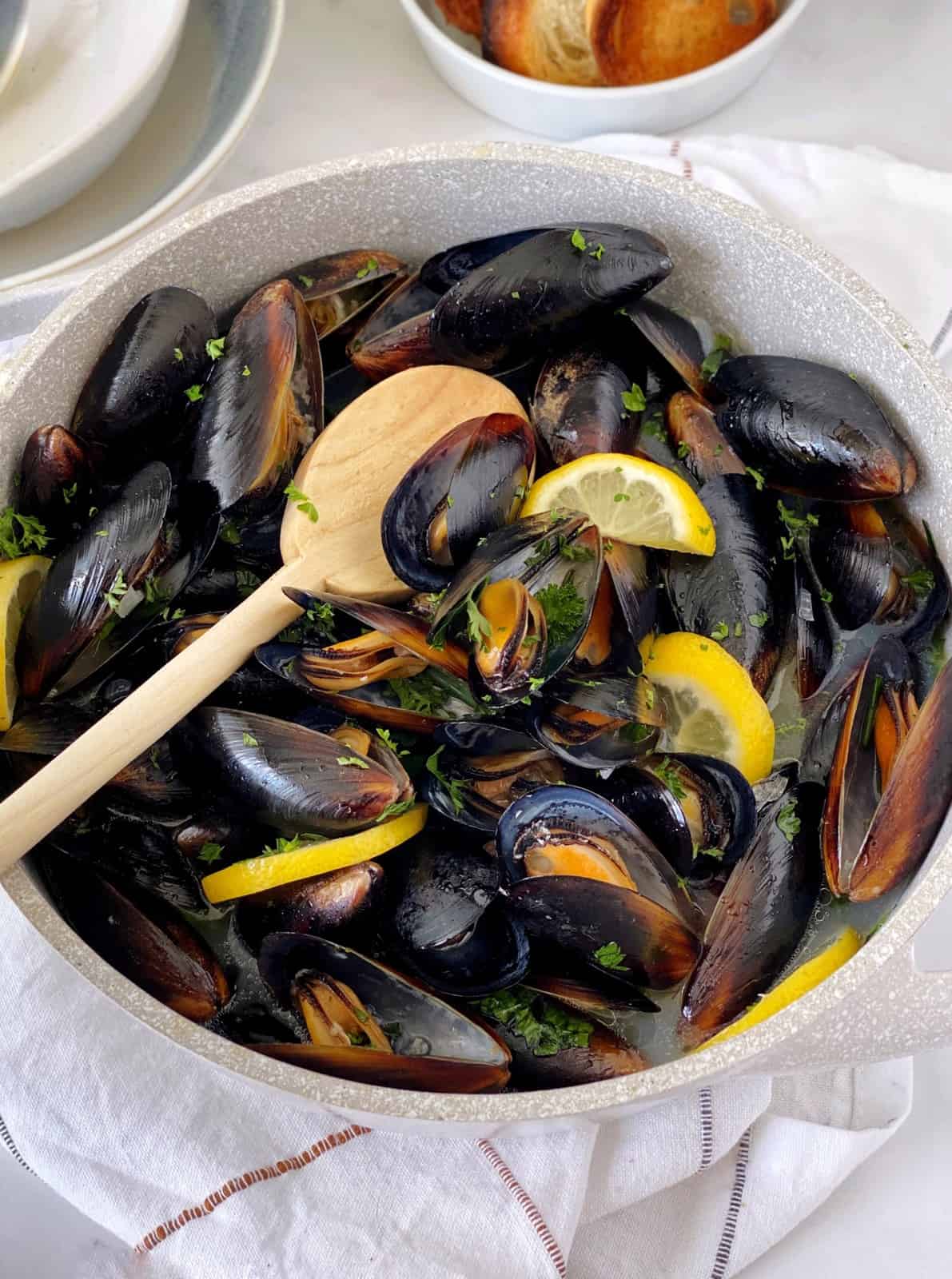 black mussels in bowl with spatula 