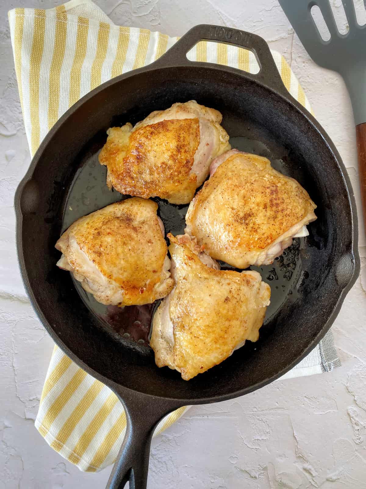 browned chicken in a skillet 