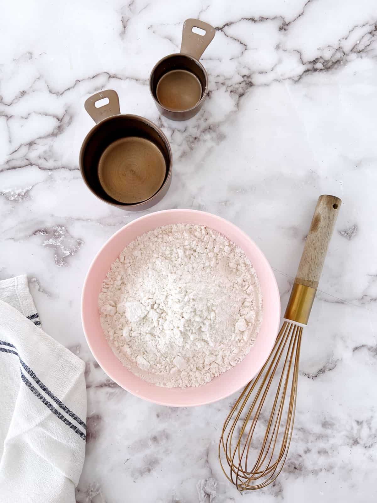 pancake mix and empty measuring cups with whisks