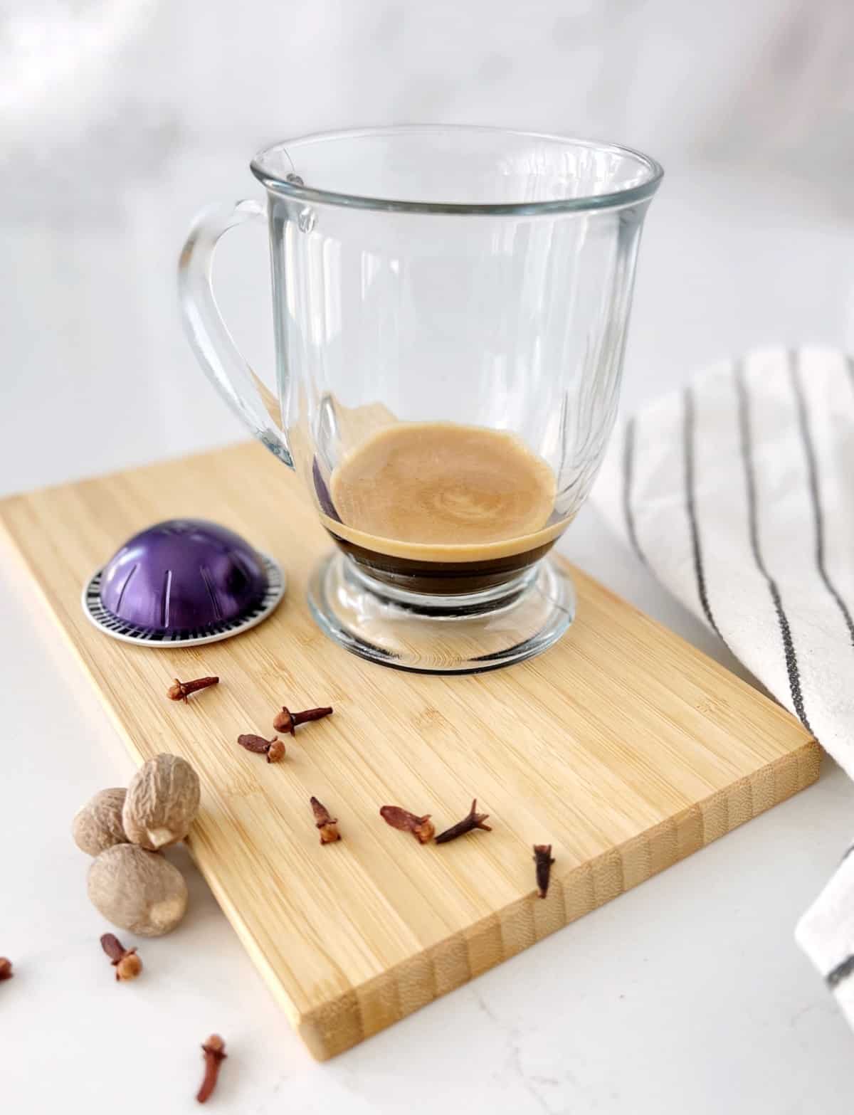 glass with espresso on a board
