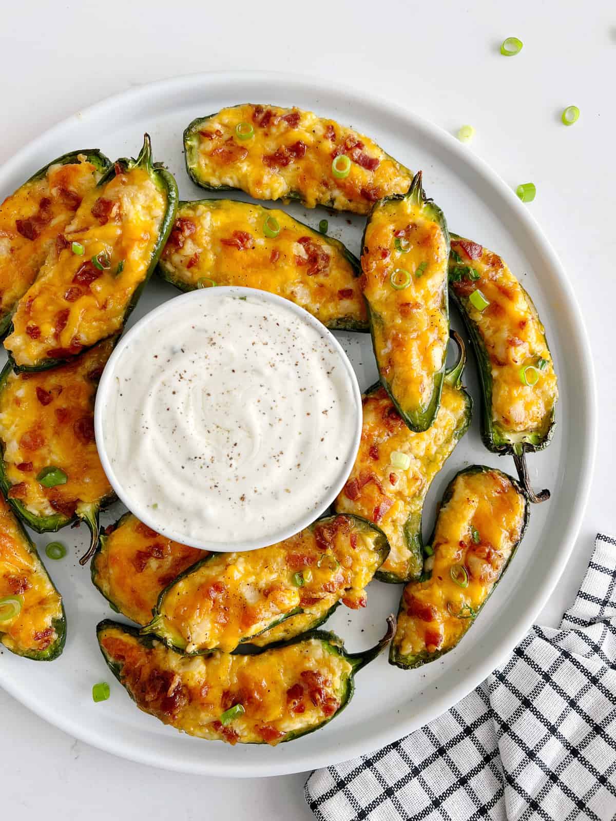 cooked jalapeno poppers with ranch in the middle 