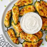 plate of jalapeno poppers with ranch dip in the middle