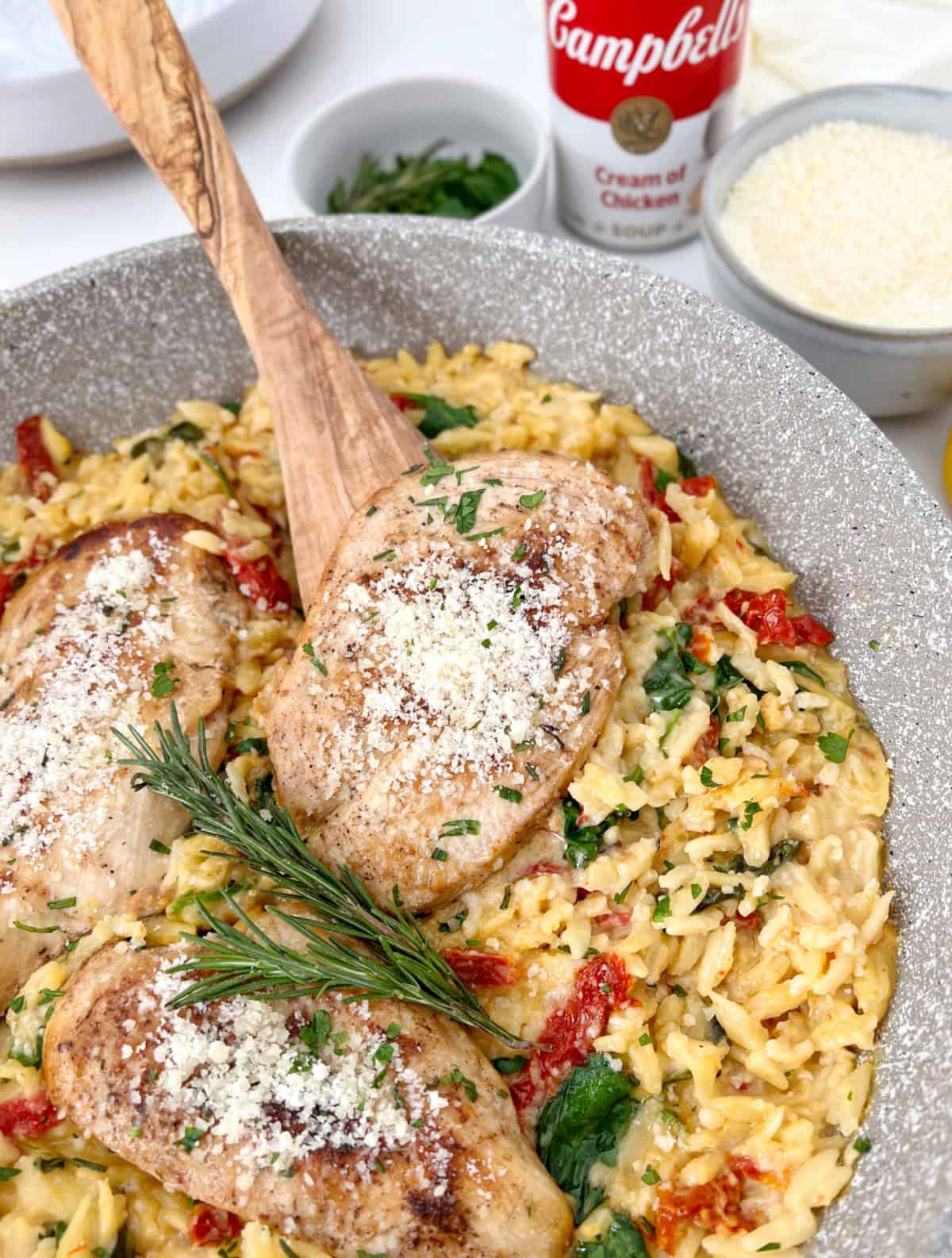 chicken orzo in a pan with garnish 