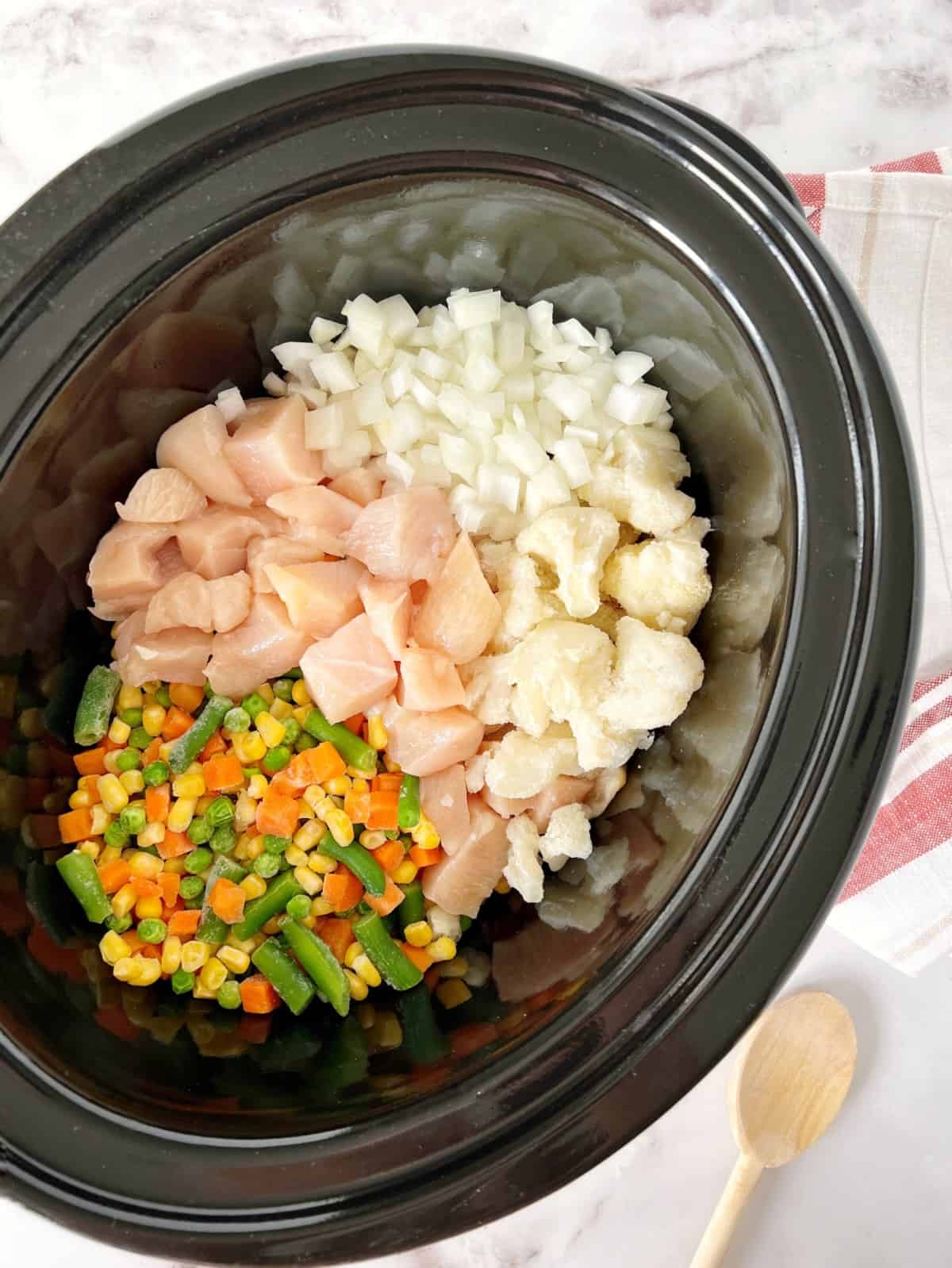 crock pot with chicken pot pie in a slow cooker