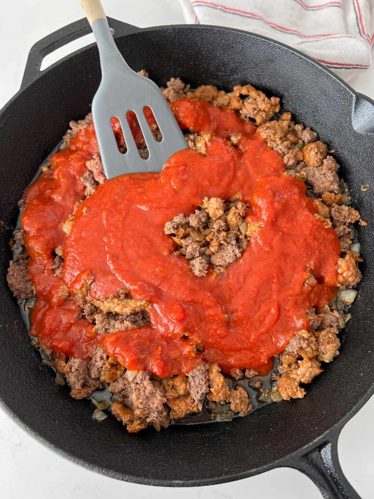 skillet with ground meat and sauce 