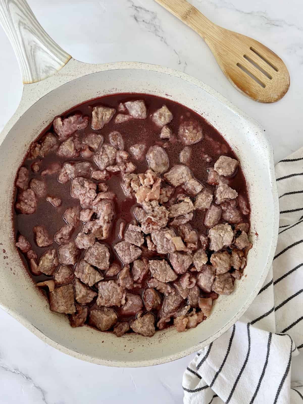 beef stew with wine in a pan 