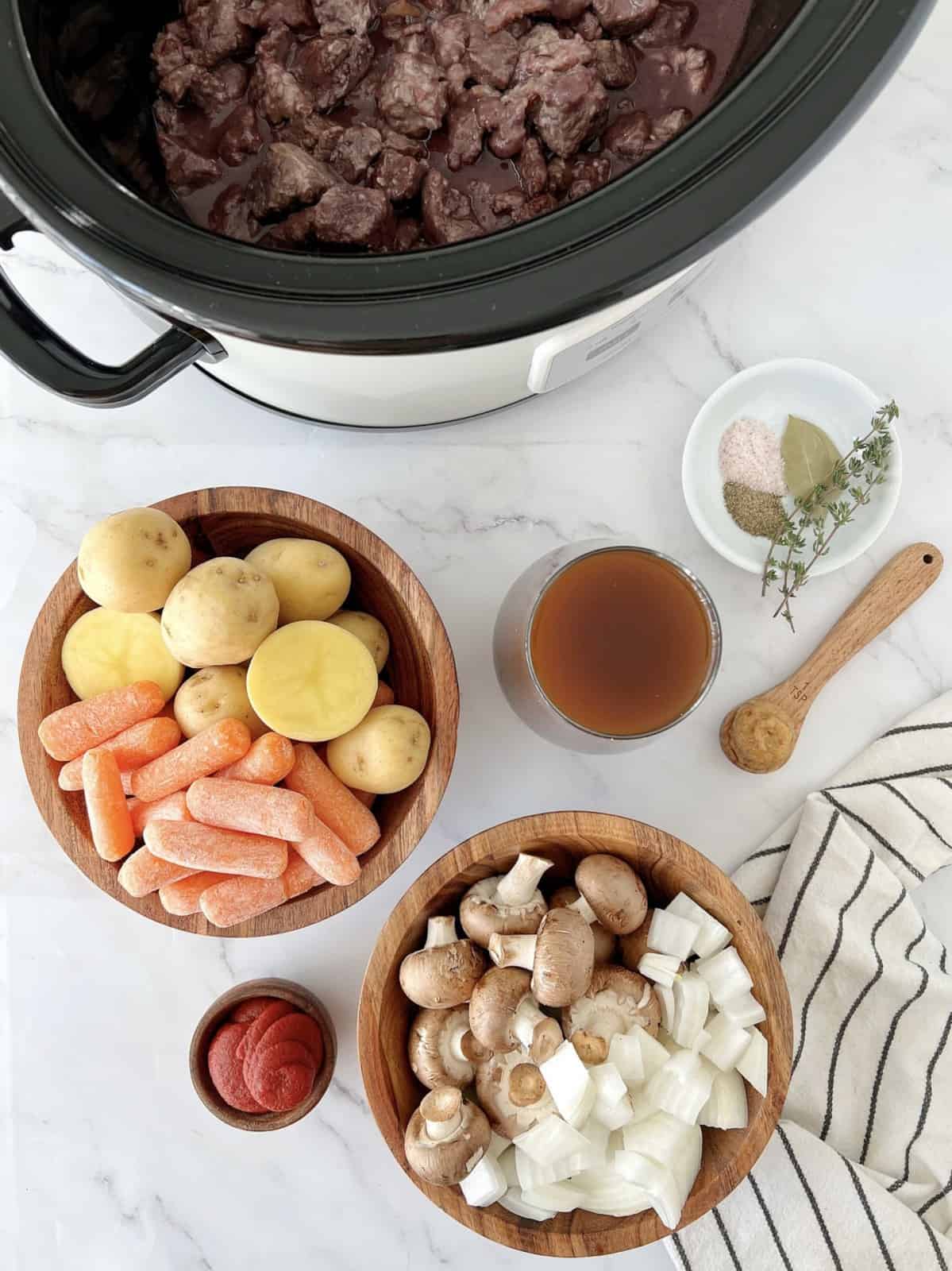 beef in slow cooker with veggies on the side