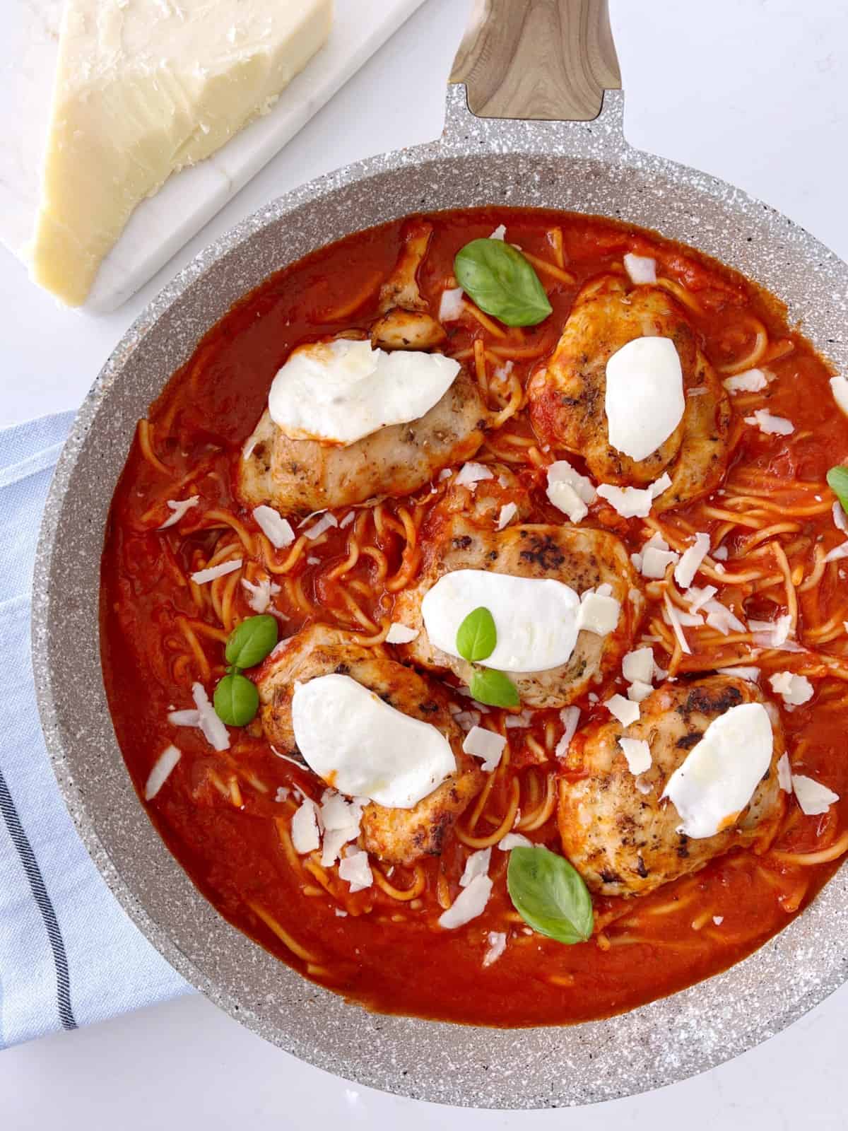 parmesan chicken with tomato sauce in a pan 