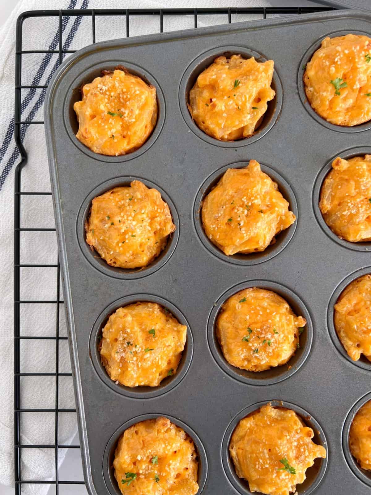 baked mac and cheese bites in a muffin tin 