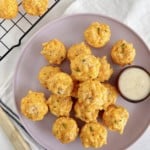 mac and cheese balls on a plate next to a baking rack