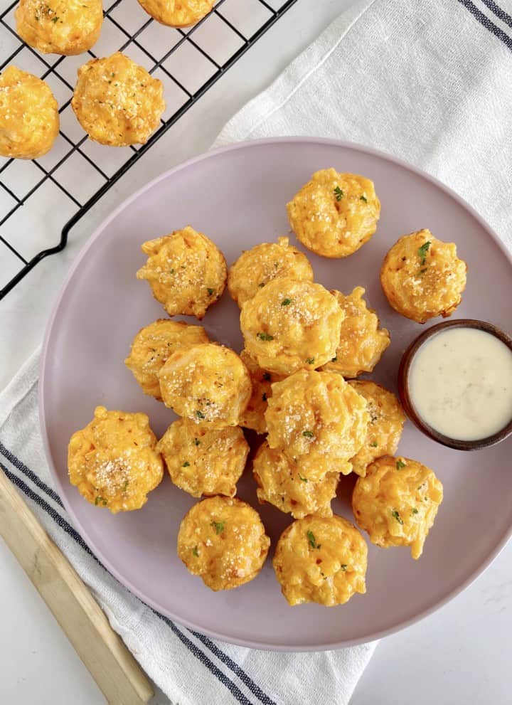 mac and cheese balls on a plate next to a baking rack