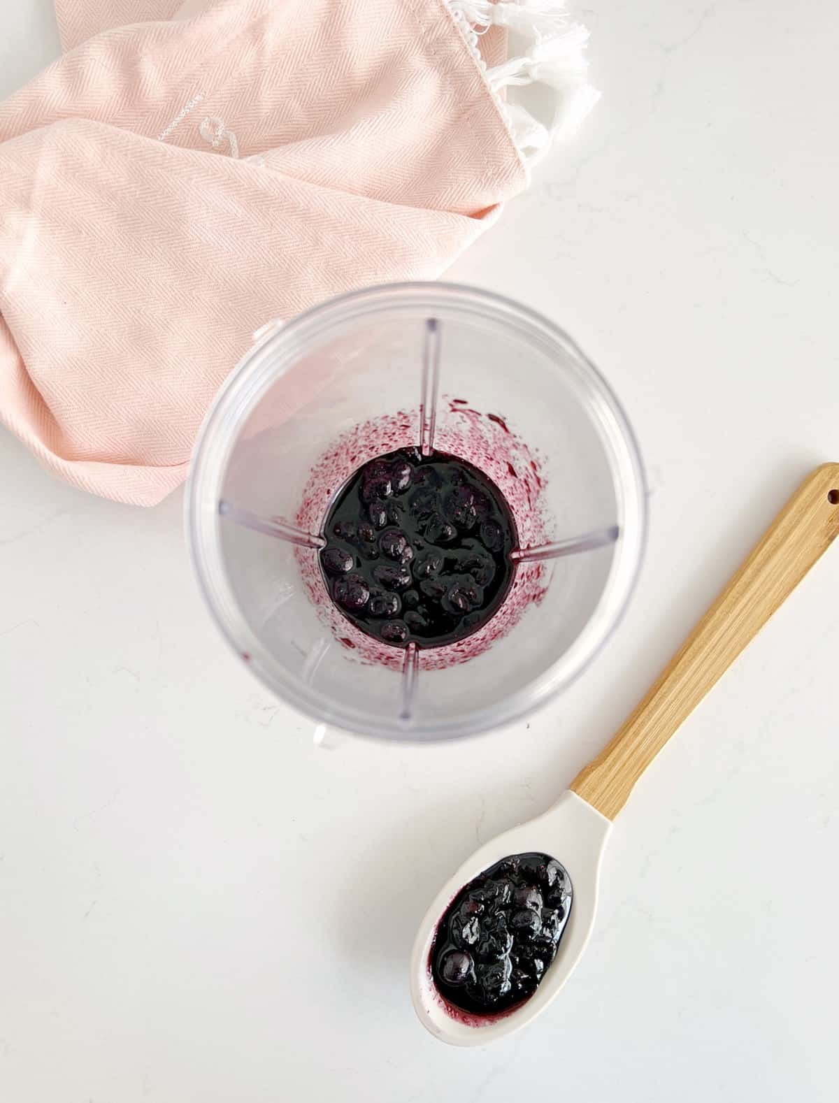 blueberry puree in a blender with a spoo 
