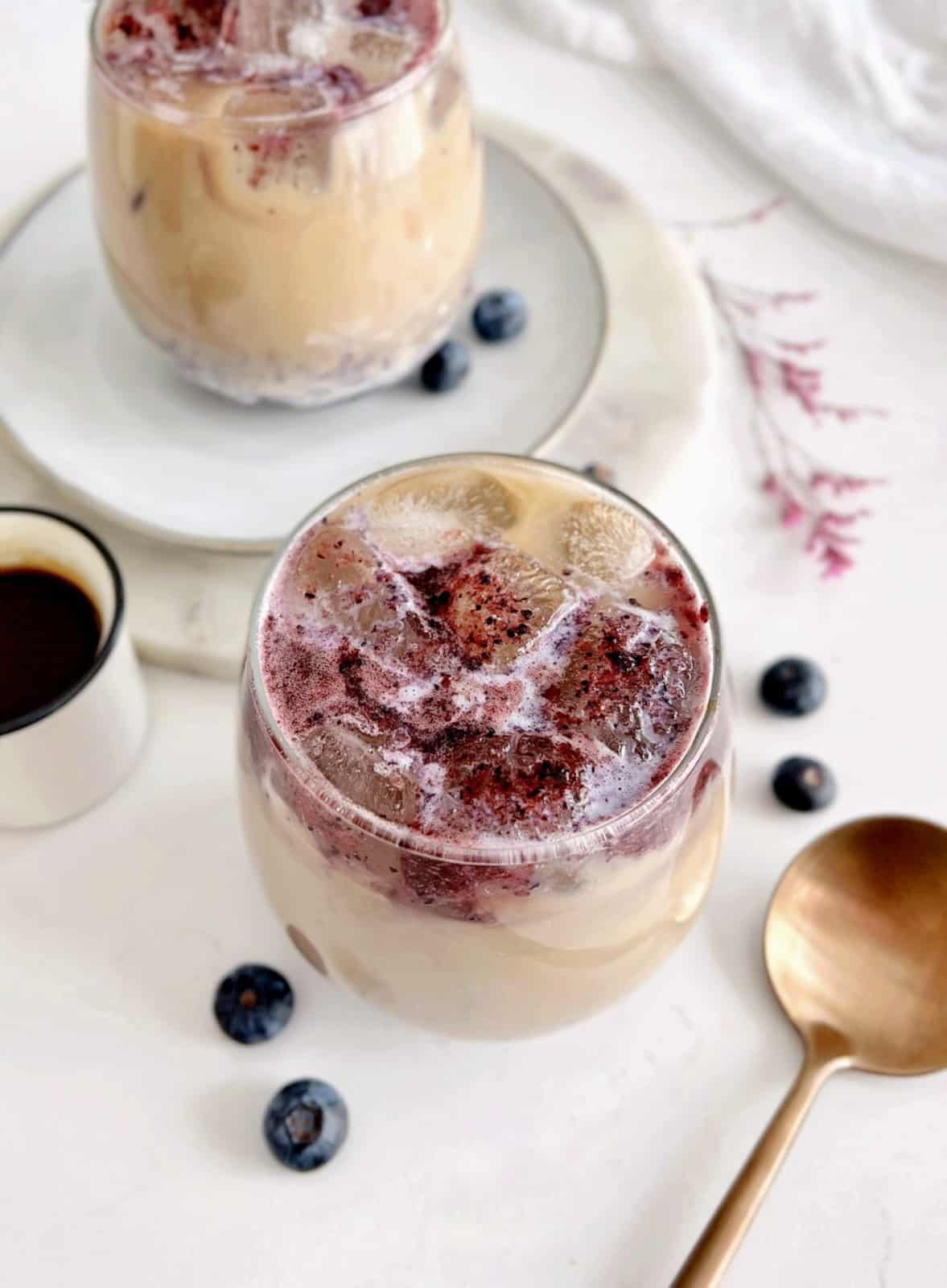 blueberry latte next to a spoon