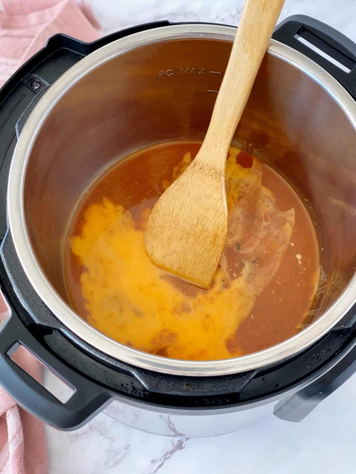 slurry of cornstarch with sauce in a pressure cooker 