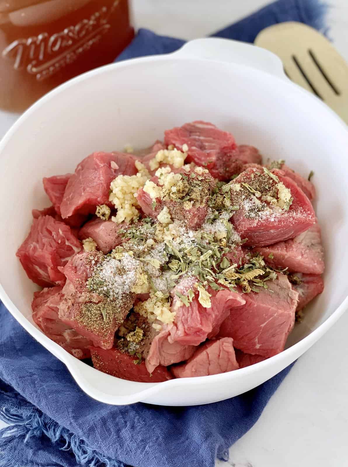 meat with seasonings on top in a bowl 