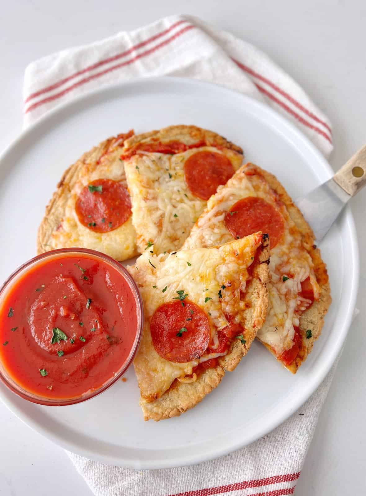 high protein piezza sliced on a late