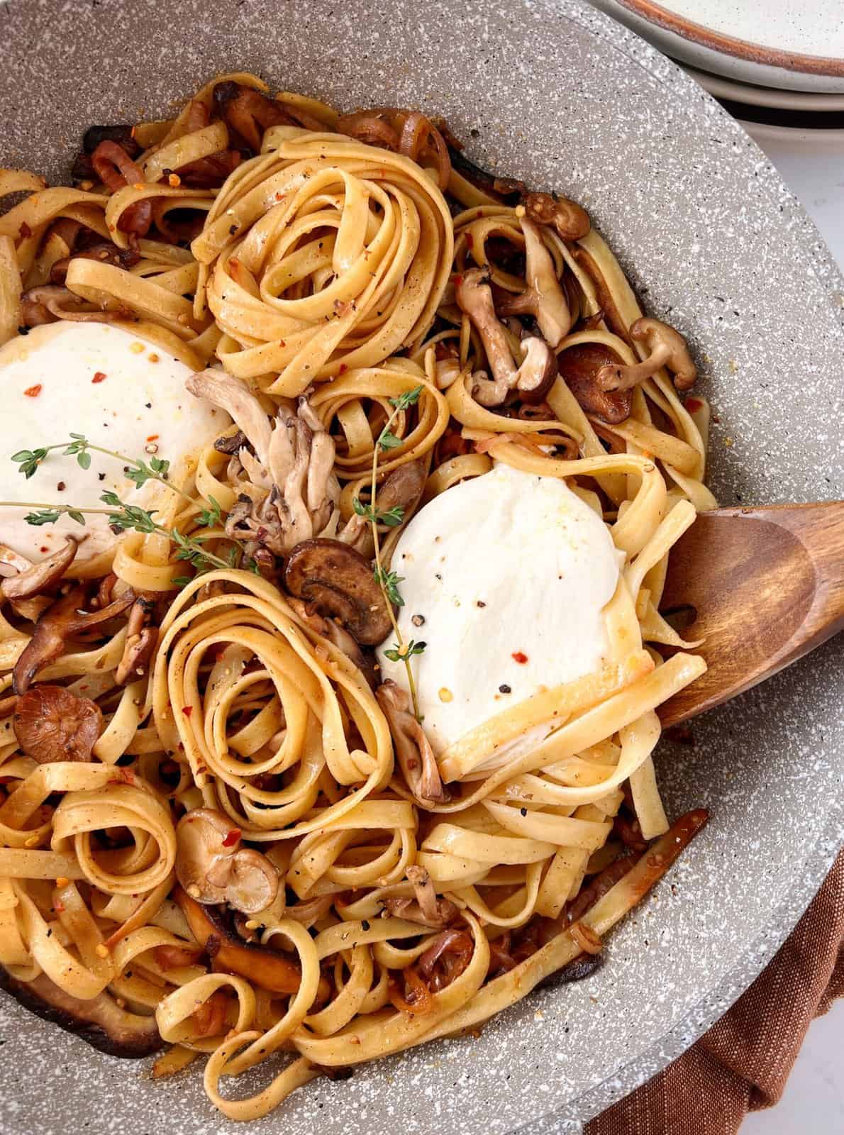 burrata and pasta with a wooden spoon 