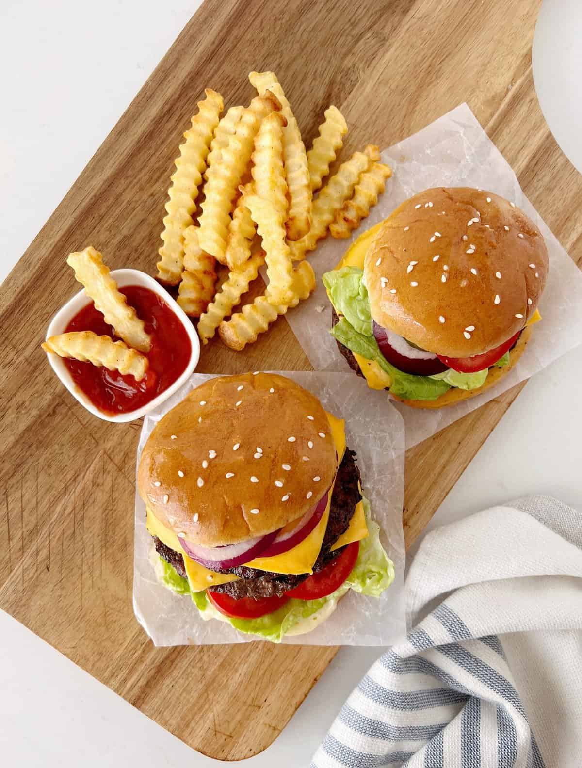 two burgers with fries 