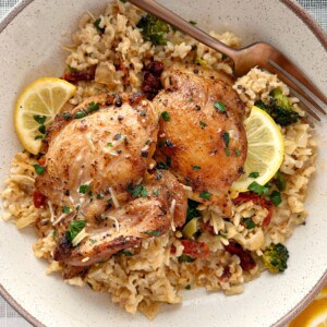 plate of chicken and rice with lemon