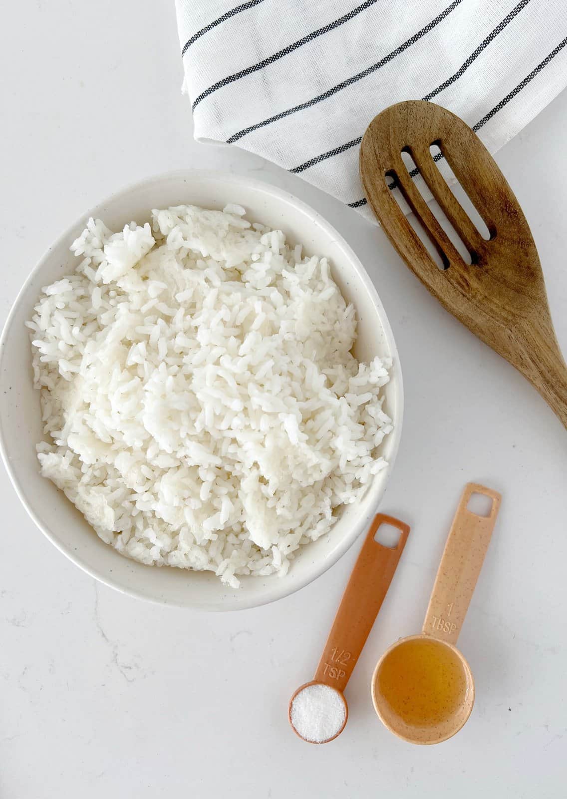 rice in a bowl with rice vinegar on the side 