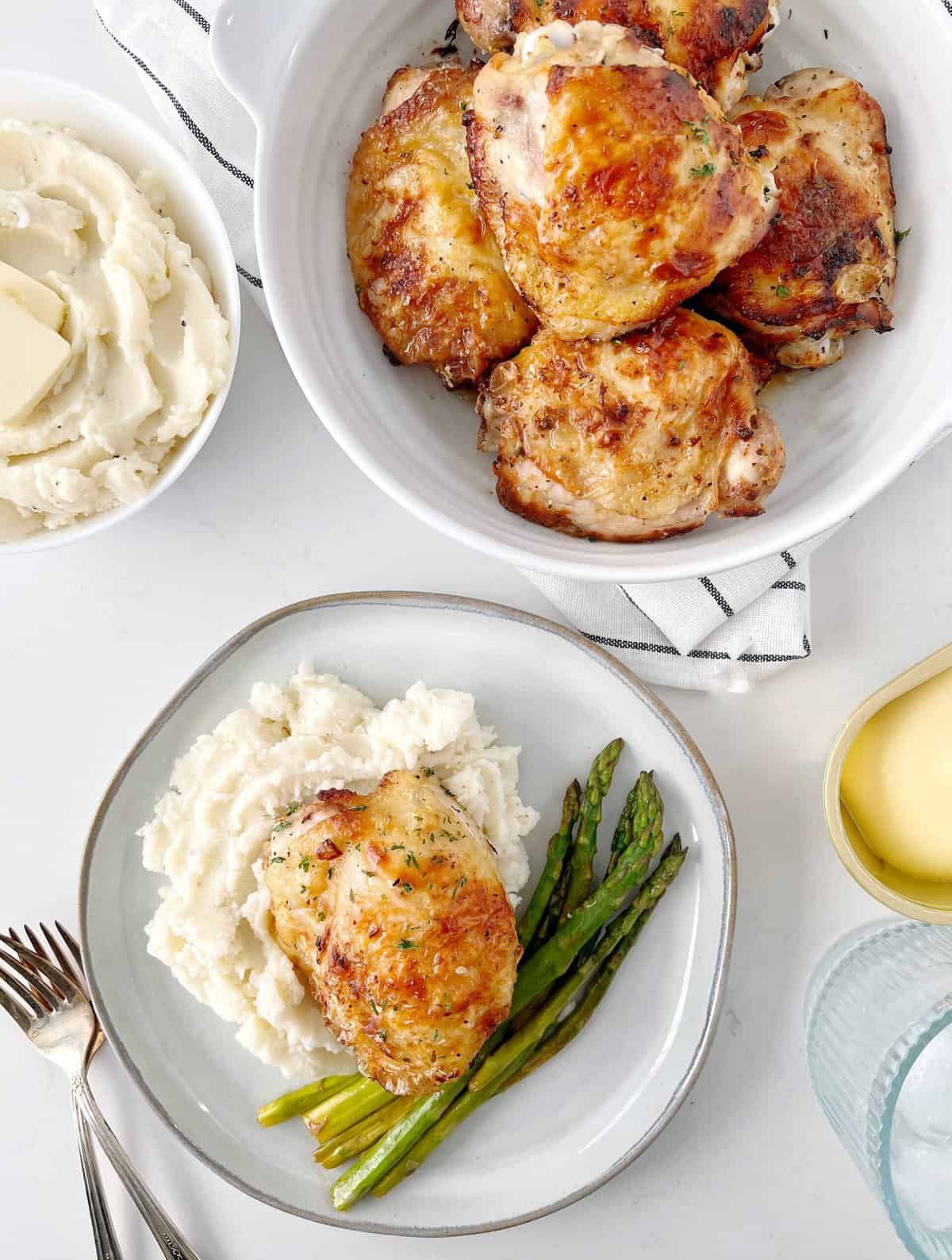 bowl of chicken thighs, next to plated chicken thighs with mashed potatoes and green beans
