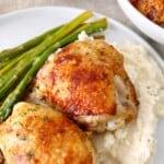 close up of chicken with mashed potatoes and green beans