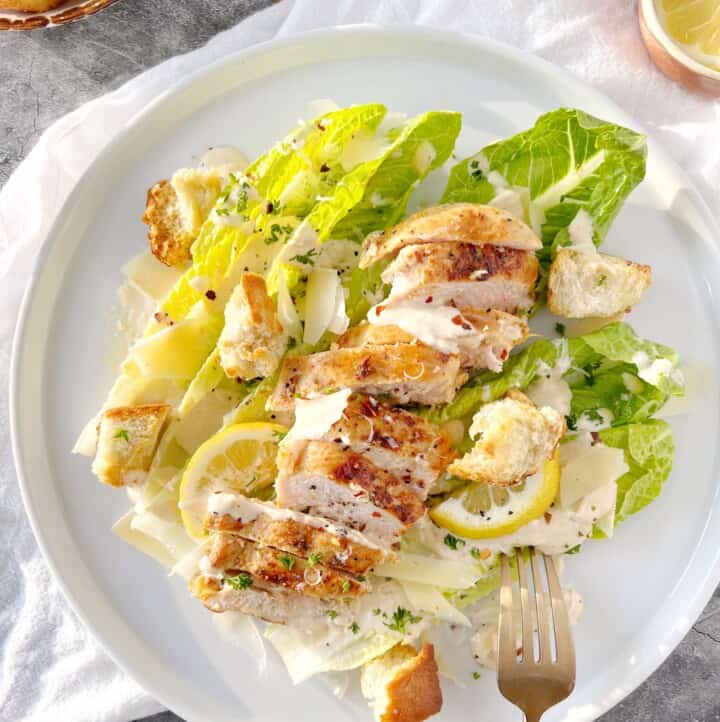 caesar salad with chicken on a plate