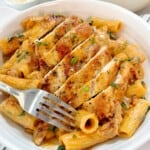 plated pasta with chicken and garnish on top