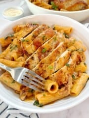 plated pasta with chicken and garnish on top